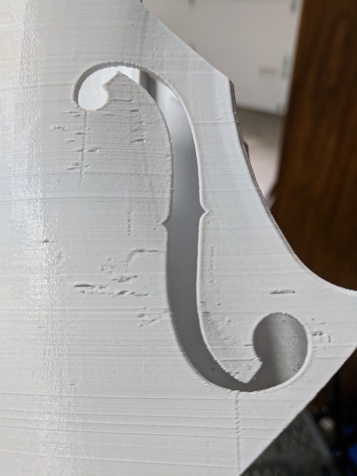 Closeup of violin scroll printed on FDM with holes